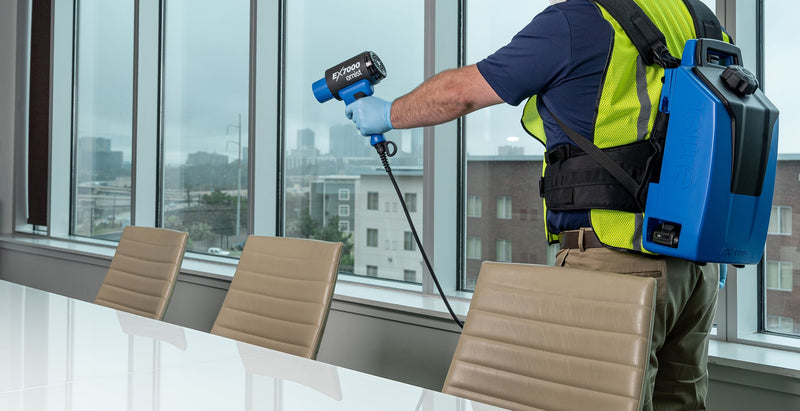 EMist EX7000 in use in a conference room, operator wearing the power pack and harness
