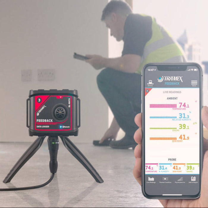 Tramex Flooring Master Kit - FMK A man using a Tramex meter with an iPad app, displaying live readings while inspecting flooring in a professional setting.