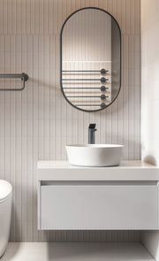 Laviva 313MFPIL-1832MB Pill 18" x 32" Matte Black mirror, installed above a vanity