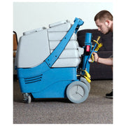 man inserting heater into edic galaxy pro 17 gallon box carpet extractor with 500 psi pump.