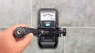 Tramex ME5 - Moisture Encounter ME5: Image showing the ME5 moisture meter mounted on a tile wall using an extension handle clamp, featuring a clear display and ergonomic design for professional moisture measurement.