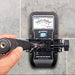 Tramex ME5 - Moisture Encounter ME5: Image showing the ME5 moisture meter mounted on a tile wall using an extension handle clamp, featuring a clear display and ergonomic design for professional moisture measurement.