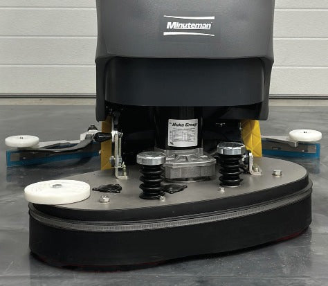 Minuteman E26 ECO twin-disc deck close-up with bumper rollers and side squeegee blades (floor pads sold separately)