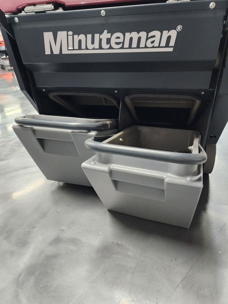 Minuteman Kleen Sweep 32R twin debris hoppers pulled out from the rear