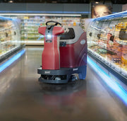Minuteman RoboScrub 20 driving through a refrigerated store aisle with its camera light on