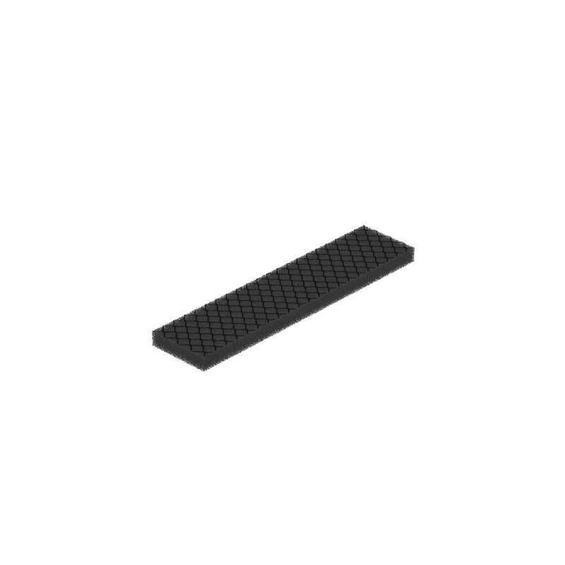Black textured air-freshening filter insert included in the Care Kit