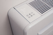 Close-up of the Monoblock's top control panel with temperature display and touch buttons beside the intake grille