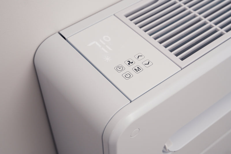 Close-up of the Monoblock's top control panel with temperature display and touch buttons beside the intake grille