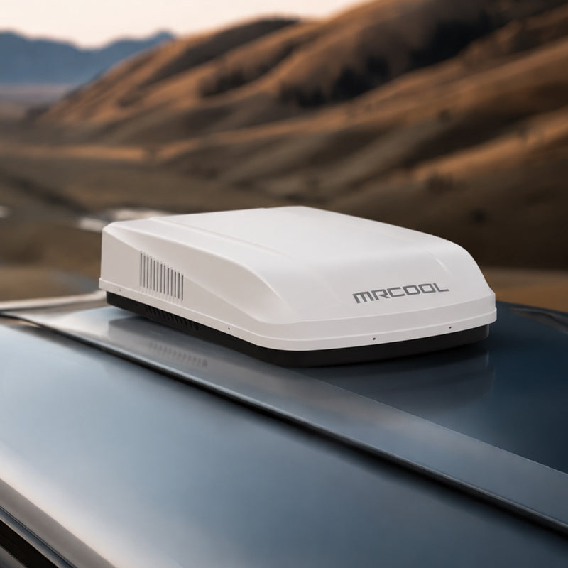White TravelCool on an RV roof with hills and a winding road behind