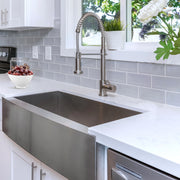 Nantucket Sinks APRON332010-16 installed under white quartz with a spring faucet and subway tile