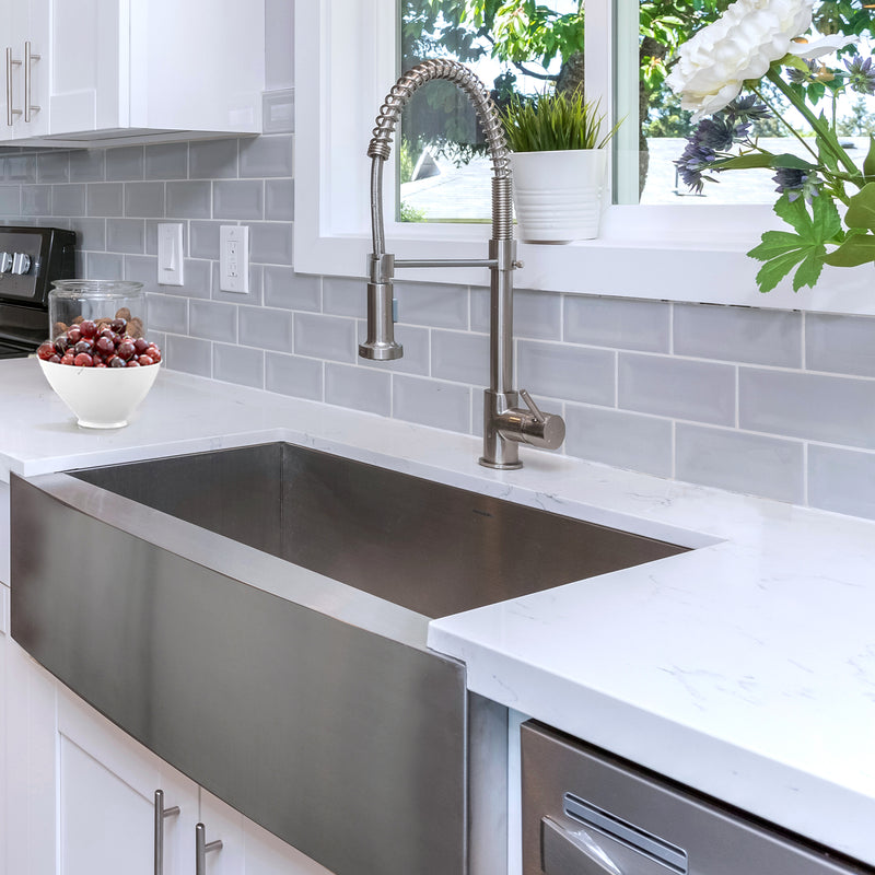 Nantucket Sinks APRON332010-16 installed under white quartz with a spring faucet and subway tile