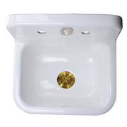 Nantucket Sinks CI-2218-FBSBSET looking down into the white basin with the satin brass grid drain