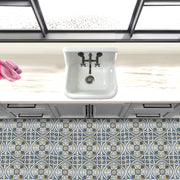 Nantucket Sinks CI-2218WNRG cast iron utility sink under a window above patterned tile, top view