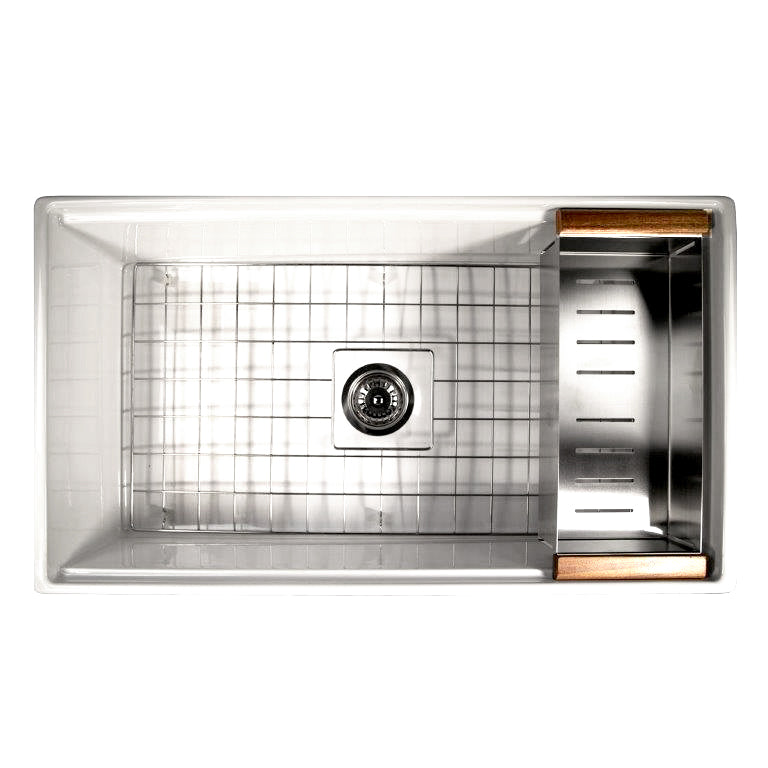 Nantucket Sinks DC-TFCPS colander resting on the ledge of a stainless workstation sink beside the bottom grid