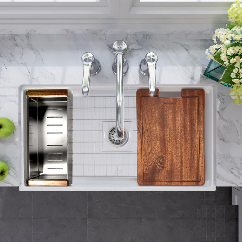 Nantucket Sinks DC-TFCPS colander and wood cutting board on a white fireclay workstation sink, top view
