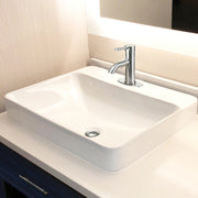 Nantucket Sinks DI-2317-R1 white drop-in sink on a vanity with a single-hole chrome faucet