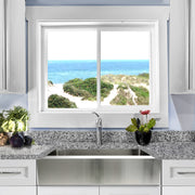 Nantucket Sinks EZApron30 installed in granite under a window with an ocean view