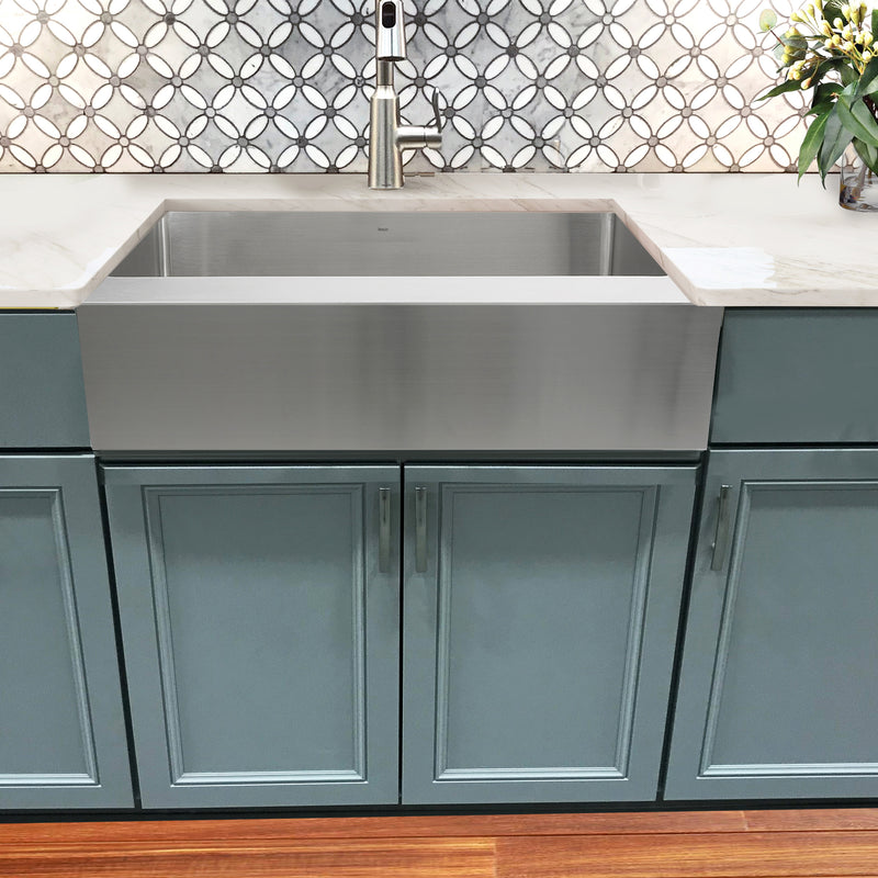 Nantucket Sinks EZApron33-9 installed over teal cabinets with a patterned tile backsplash