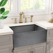 Nantucket Sinks FCFS2418S-Concrete Concrete farmhouse sink in a grey cabinet kitchen with a brass bridge faucet