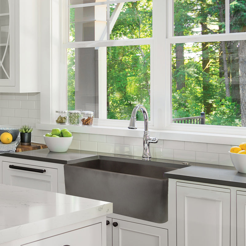 Nantucket Sinks FCFS3020S-Concrete Concrete farmhouse sink under a window in a white shaker kitchen