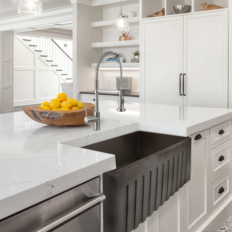 Nantucket Sinks FCFS3020S-Concrete Concrete farmhouse sink with fluted apron in a white marble island