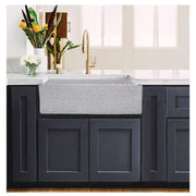 Nantucket Sinks FCFS3020S-PietraSarda Pietra Sarda farmhouse sink in navy shaker cabinets with a brass faucet