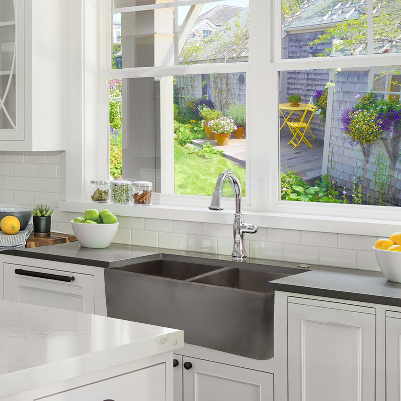 Nantucket Sinks FCFS3318D-Concrete Concrete double bowl farmhouse sink under a garden window in a white kitchen