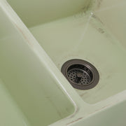 Nantucket Sinks FCFS3318D-ShabbyGreen close-up of the distressed Shabby Green glaze at the bowl divider and drain