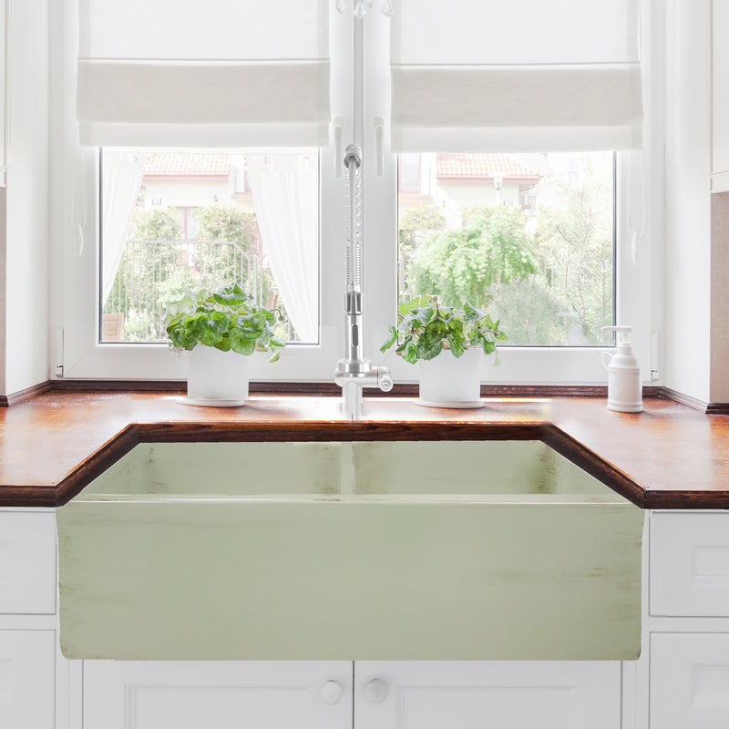 Nantucket Sinks FCFS3318D-ShabbyGreen Shabby Green double bowl farmhouse sink below a window with a wood counter