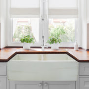Nantucket Sinks FCFS3318D-ShabbyStraw Shabby Straw double bowl farmhouse sink below a window with a wood counter