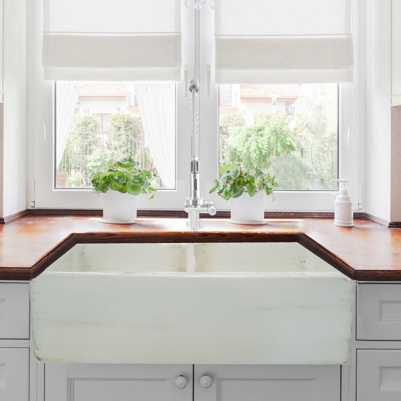 Nantucket Sinks FCFS3318D-ShabbyStraw Shabby Straw double bowl farmhouse sink below a window with a wood counter