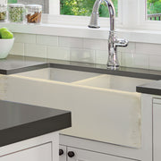 Nantucket Sinks FCFS3318D-ShabbyStraw Shabby Straw double bowl farmhouse sink under a dark counter in a white kitchen