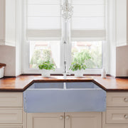 Nantucket Sinks FCFS3318D-ShabbySugar Shabby Sugar double bowl farmhouse sink below a window with a wood counter