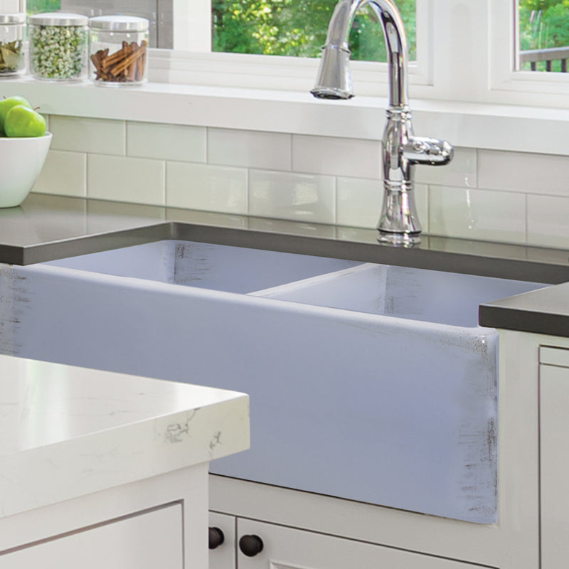 Nantucket Sinks FCFS3318D-ShabbySugar Shabby Sugar double bowl farmhouse sink under a dark counter in a white kitchen