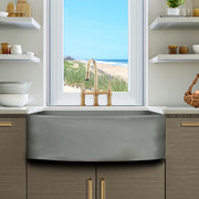 Nantucket Sinks FCFS3320CA-C Concrete curved apron farmhouse sink in wood cabinets under a beach-view window