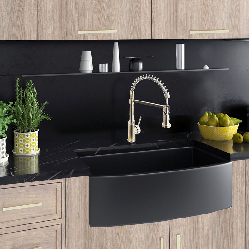 Nantucket Sinks FCFS3320CA-MB Matte Black curved apron farmhouse sink in wood cabinets with black stone counter