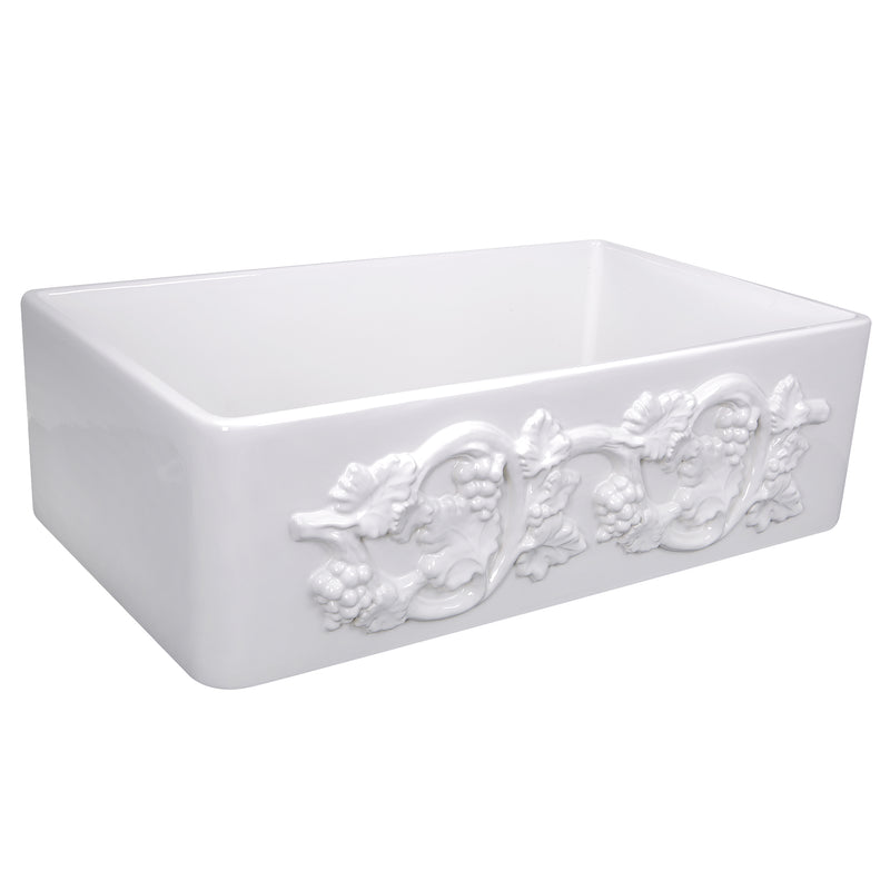 Nantucket Sinks FCFS3320S-Grapes white fireclay farmhouse sink, three-quarter view of the carved Grapes apron