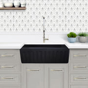 Nantucket Sinks FCFS3320S-MatteBlack Matte Black farmhouse sink showing the fluted apron in grey cabinets
