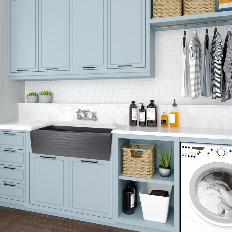 Nantucket Sinks FCFS3320S-MB-Waves Matte Black Waves farmhouse sink in a light blue laundry room