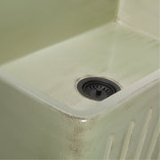 Nantucket Sinks FCFS3320S-ShabbyGreen close-up of the distressed Shabby Green glaze and fluted apron edge by the drain