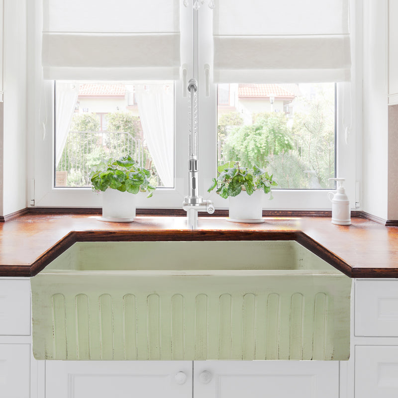 Nantucket Sinks FCFS3320S-ShabbyGreen Shabby Green farmhouse sink with fluted apron below a window, wood counter