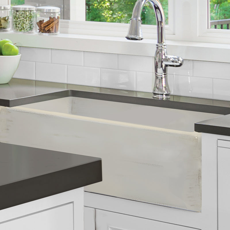 Nantucket Sinks FCFS3320S-ShabbyStraw Shabby Straw farmhouse sink under a dark counter in a white kitchen