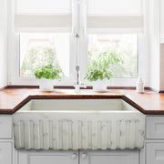 Nantucket Sinks FCFS3320S-ShabbyStraw Shabby Straw farmhouse sink with fluted apron below a window, wood counter
