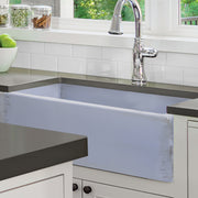 Nantucket Sinks FCFS3320S-ShabbySugar Shabby Sugar farmhouse sink under a dark counter in a white kitchen