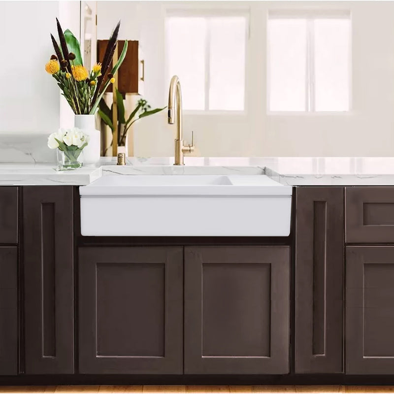 Nantucket Sinks FCFS36-DB drainboard farmhouse sink in dark wood cabinets with a brass faucet
