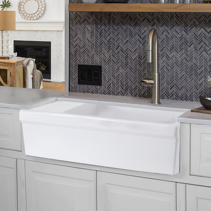 Nantucket Sinks FCFS36-DB drainboard farmhouse sink below a herringbone tile wall and open wood shelf