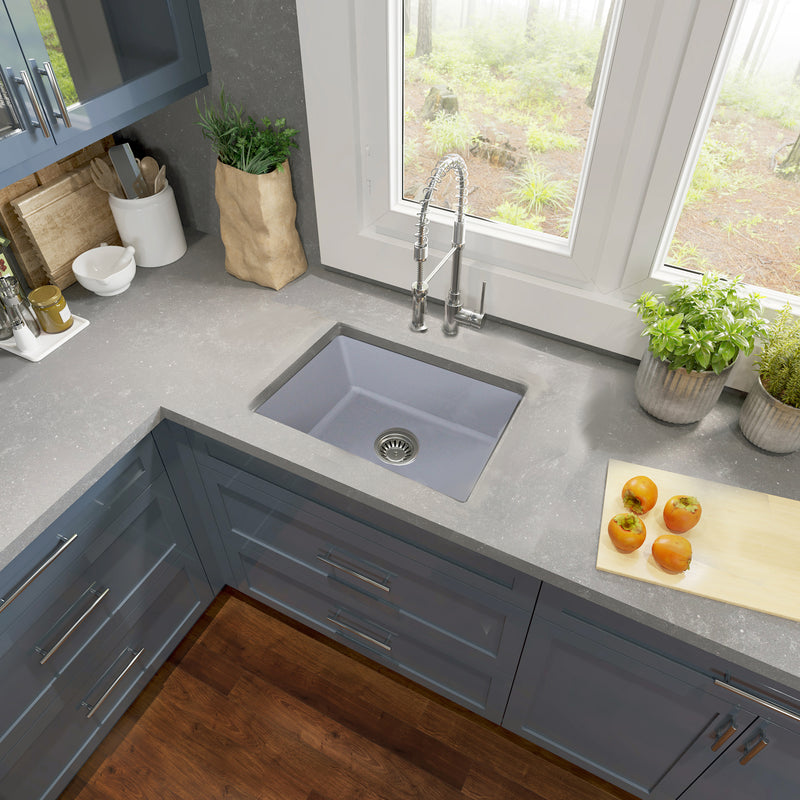 Nantucket Sinks ISFC24GR-SB1 Matte Grey sink in a grey corner counter with blue cabinets by the window
