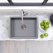 Nantucket Sinks ISFC24GR-SB1 Matte Grey sink from above in a white marble counter with green apples