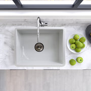 Nantucket Sinks ISFC24W-SB1 white single bowl sink from above in a marble counter with green apples