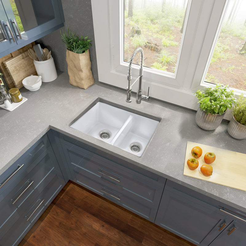 Nantucket Sinks ISFC24x18W-DB2 67/33 double bowl sink in a grey corner counter with blue cabinets